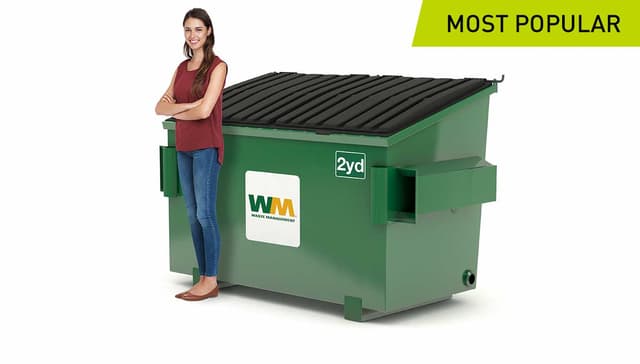 Woman stands next to a 2-yard dumpster from Waste Management- the most popular size for businesses.