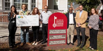 WM presents a check to Bridgewater College students and community representatives